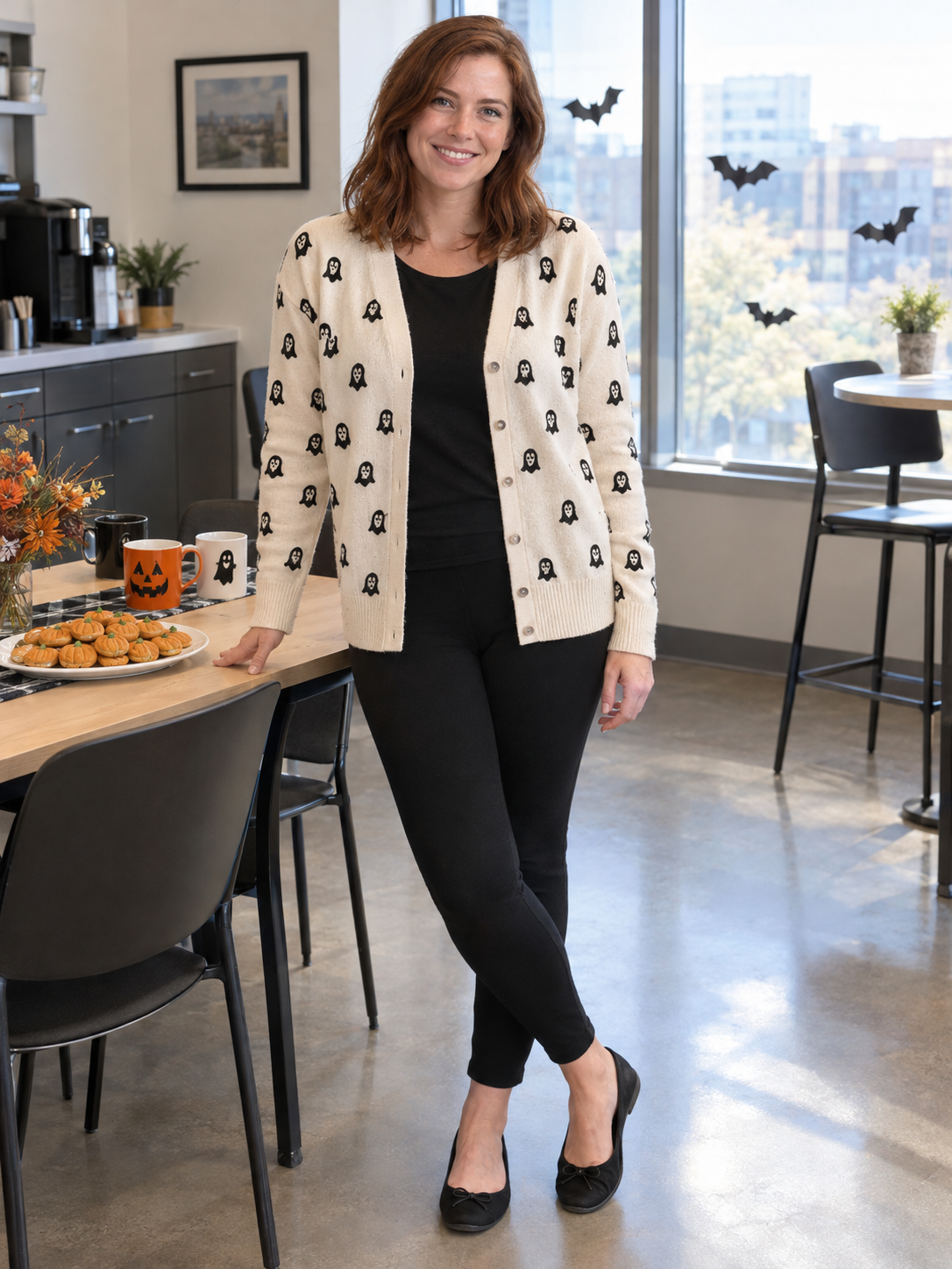 Mom in a cream ghost print cardigan and black leggings in an office break room