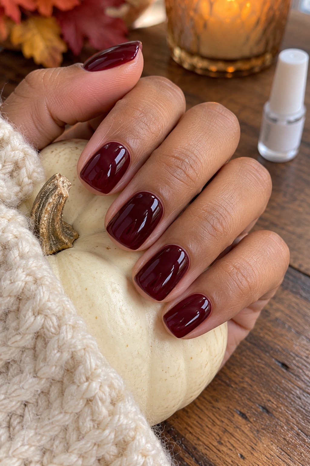Short square burgundy fall press on nails on a white pumpkin